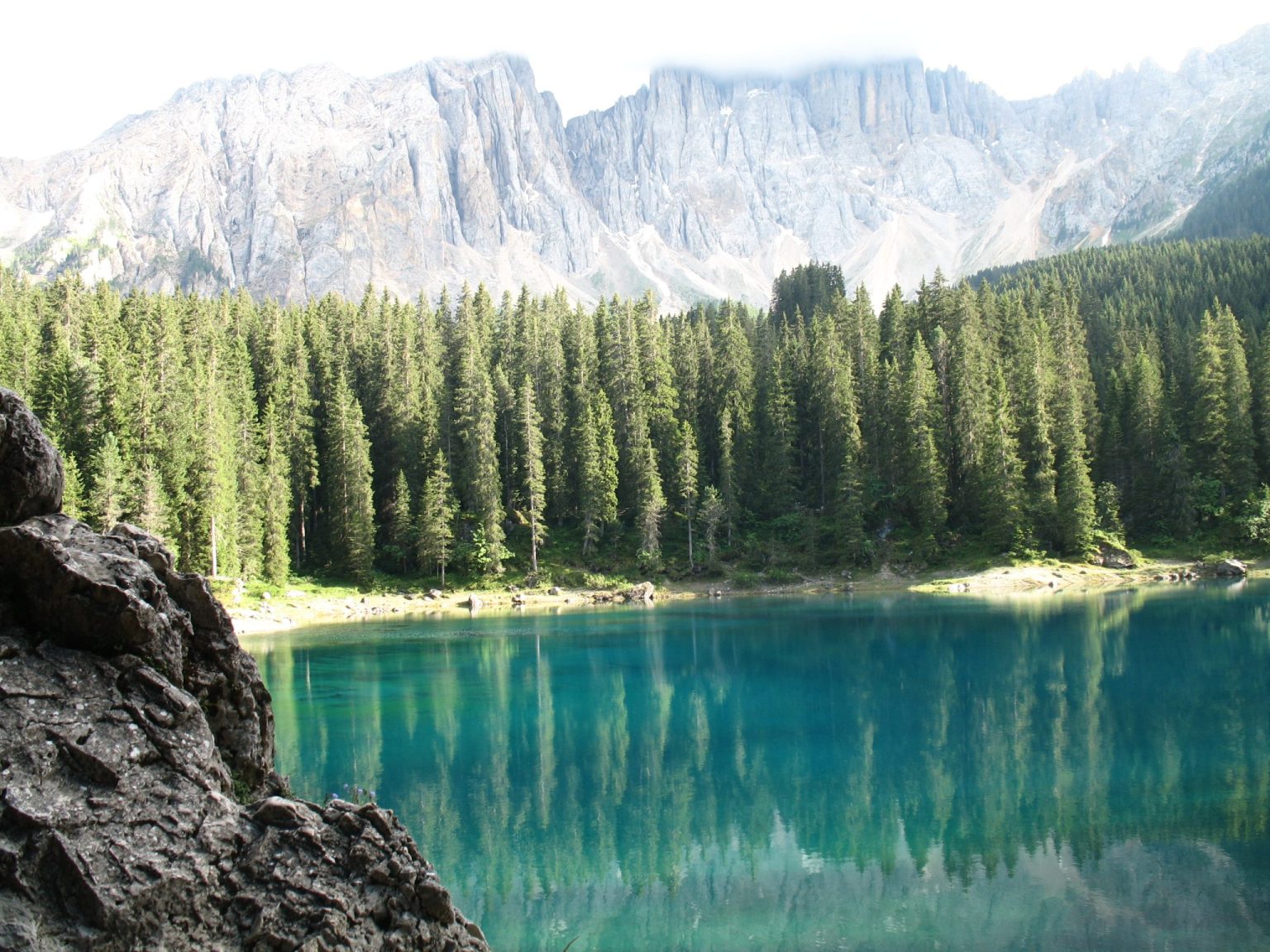 Der Karersee mit dem Latemarmassiv im Hintergrund