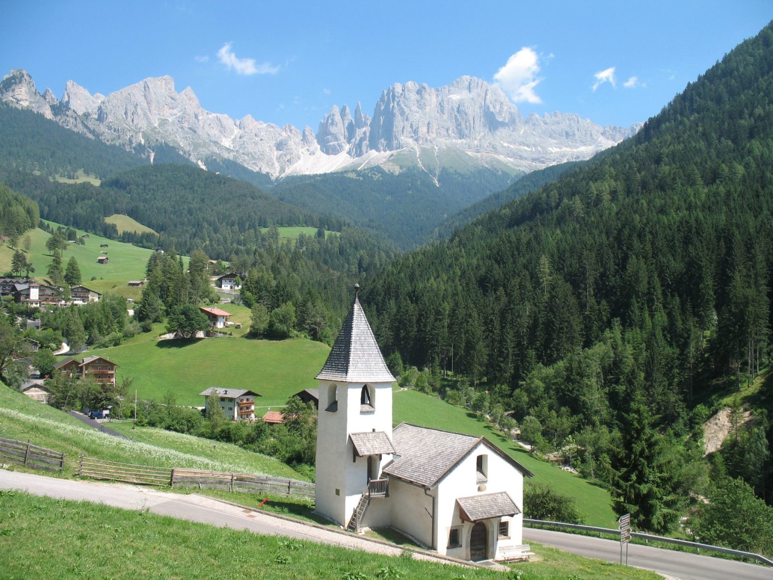 Das Kirchlein St. Zyprian mit dem Rosengarten im Hintergrund